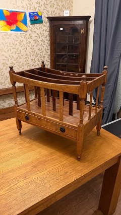 Unbranded, antique music and magazine holder, full front view on a wooden table