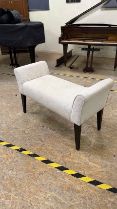 Unbranded, upholstered duet piano stool, front and left side view in the showroom